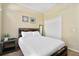 Cozy bedroom with a double bed, nightstand, and ample closet space at 9016 Murano Mews Ct, Kissimmee, FL 34747