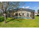 Relaxing screened pool area with patio furniture and lush landscaping at 9016 Murano Mews Ct, Kissimmee, FL 34747