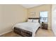 Well-lit bedroom with a double bed, nightstand, and window at 9016 Murano Mews Ct, Kissimmee, FL 34747