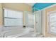 Spa-like bathroom with soaking tub, walk-in shower, and private access to backyard at 9016 Murano Mews Ct, Kissimmee, FL 34747