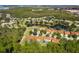 Community overview featuring numerous houses and a central lake at 9016 Murano Mews Ct, Kissimmee, FL 34747