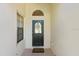 Front entry with a black door and welcome mat at 9016 Murano Mews Ct, Kissimmee, FL 34747