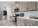 Modern kitchen with taupe cabinets and white quartz countertops at 14442 Noto Ave, Clermont, FL 34714