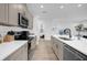 Modern kitchen with white quartz countertops and taupe cabinets at 14442 Noto Ave, Clermont, FL 34714