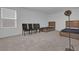 Bedroom with two twin beds, four chairs, and a floor lamp at 14442 Noto Ave, Clermont, FL 34714