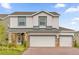 Two story home with three car garage and stone accents at 14442 Noto Ave, Clermont, FL 34714