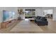 Living room with sectional sofa and large TV at 14442 Noto Ave, Clermont, FL 34714