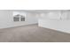 Bright loft area with neutral carpeting and window at 14442 Noto Ave, Clermont, FL 34714