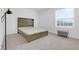 Bright bedroom featuring a wood bed frame and window at 14442 Noto Ave, Clermont, FL 34714
