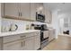 Modern kitchen with taupe cabinets and white quartz countertops at 14442 Noto Ave, Clermont, FL 34714