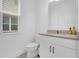 Clean and bright bathroom with white cabinets at 14442 Noto Ave, Clermont, FL 34714
