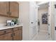 Laundry room with cabinets and built-in shelving at 4072 Bannock Ave, Tavares, FL 32778