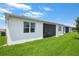 Well-maintained home exterior with a screened patio and lush lawn at 4072 Bannock Ave, Tavares, FL 32778