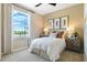 Cozy bedroom with a double bed, large window, and tasteful decor at 4072 Bannock Ave, Tavares, FL 32778