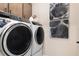 Bright laundry room, featuring a washer and dryer, and stylish wall art at 4072 Bannock Ave, Tavares, FL 32778