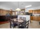 Open kitchen with breakfast bar, looking into living and dining areas at 4523 Ashtubula Ct, Orlando, FL 32818
