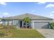 Gray house with a two-car garage and palm tree at 4523 Ashtubula Ct, Orlando, FL 32818