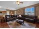 Relaxing living room with sectional sofa, coffee table, and large windows at 4523 Ashtubula Ct, Orlando, FL 32818