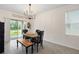 Charming dining area with a rustic farmhouse table and bench at 6883 Botanic Blvd, Harmony, FL 34773