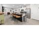 Modern kitchen with island, granite countertops, and stainless steel appliances at 6883 Botanic Blvd, Harmony, FL 34773