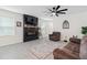 Spacious living room featuring a modern fireplace and comfortable seating at 6883 Botanic Blvd, Harmony, FL 34773