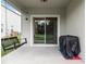 Relaxing covered patio with a swing and grill at 6883 Botanic Blvd, Harmony, FL 34773
