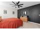 Spacious bedroom with a dark accent wall and ceiling fan at 6883 Botanic Blvd, Harmony, FL 34773