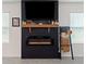 Modern electric fireplace with a stylish mantel and built-in shelving at 6883 Botanic Blvd, Harmony, FL 34773