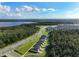 Aerial view of houses and community near a lake at 6883 Botanic Blvd, Harmony, FL 34773