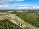 Aerial view of community with lake and conservation at 6883 Botanic Blvd, Harmony, FL 34773