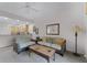 Living room with wicker furniture and access to balcony at 9051 Treasure Trove Ln # 307, Kissimmee, FL 34747
