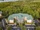 Aerial view of a multi-unit building with green roof and ample parking at 9051 Treasure Trove Ln # 307, Kissimmee, FL 34747