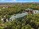 Aerial view of condo building with surrounding green space at 9051 Treasure Trove Ln # 307, Kissimmee, FL 34747