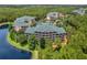 Aerial view of condo buildings and surrounding lush landscape at 9051 Treasure Trove Ln # 307, Kissimmee, FL 34747