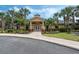 Community clubhouse with inviting entrance and landscaping at 9051 Treasure Trove Ln # 307, Kissimmee, FL 34747