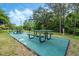 Outdoor recreation area with picnic tables and grill at 9051 Treasure Trove Ln # 307, Kissimmee, FL 34747