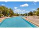 Relaxing resort-style pool with lounge chairs and umbrellas at 9051 Treasure Trove Ln # 307, Kissimmee, FL 34747