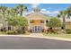 Inviting community clubhouse with landscaping and a paved pathway at 9051 Treasure Trove Ln # 307, Kissimmee, FL 34747