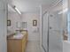 Elegant bathroom with double vanity and a large walk-in shower at 9051 Treasure Trove Ln # 307, Kissimmee, FL 34747
