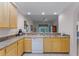 Kitchen with wood cabinets, granite counters, dishwasher at 9051 Treasure Trove Ln # 307, Kissimmee, FL 34747
