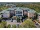 Condo building with parking and lush green surroundings at 9051 Treasure Trove Ln # 307, Kissimmee, FL 34747