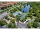 Aerial view showing community pool, clubhouse, and surrounding landscape at 9051 Treasure Trove Ln # 307, Kissimmee, FL 34747