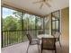Relaxing screened balcony with wooded views and seating at 9051 Treasure Trove Ln # 307, Kissimmee, FL 34747