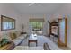 Spacious living room with comfy seating, access to balcony, and a TV at 9051 Treasure Trove Ln # 307, Kissimmee, FL 34747