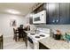 View of kitchen with white appliances and granite countertops at 976 Leeward Pl # 102, Altamonte Springs, FL 32714