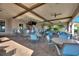 Relaxing outdoor bar with comfortable seating and a large screen TV at 1423 Bunker Dr, Davenport, FL 33896