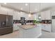 Modern kitchen with island and white cabinets at 1423 Bunker Dr, Davenport, FL 33896