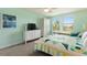Bedroom with a queen bed, dresser, and window views at 1423 Bunker Dr, Davenport, FL 33896