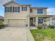 Two story house with tan exterior and brown shutters at 1927 Partin Terrace Rd, Kissimmee, FL 34744