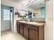 Double vanity bathroom with modern cabinetry and a large mirror at 1927 Partin Terrace Rd, Kissimmee, FL 34744